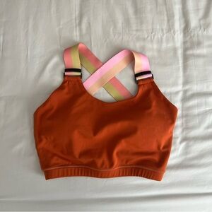 Orange sports bra with multi colored straps